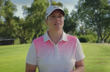 Woman with white hat on golf grounds giving testimonial